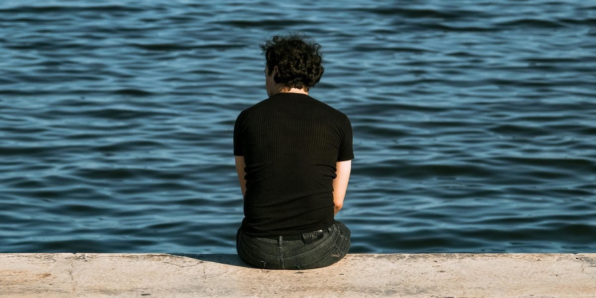 A person looking thoughtful and isolated, reflecting the common feeling of disconnection discussed in the article.