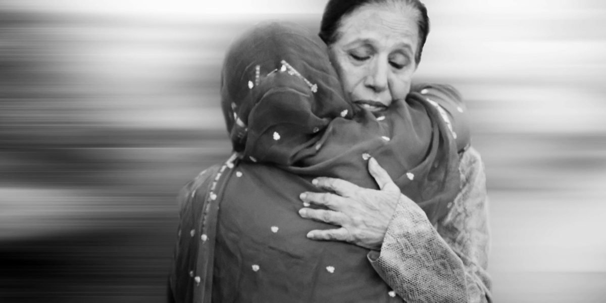 A person receiving empathetic and understanding support, indicative of a therapeutic setting for deeper emotional healing.