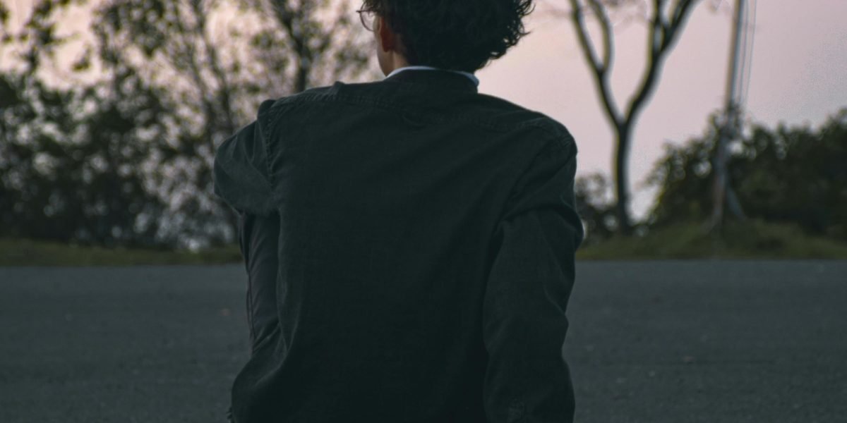 A man in a moment of quiet reflection, suggesting the internal processing of emotions that men often face due to societal expectations.