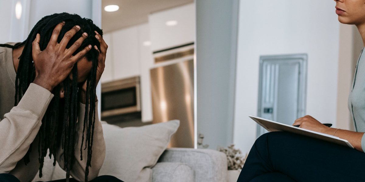 A man engaging in a conversation with a therapist, representing the crucial step of seeking professional mental health support.