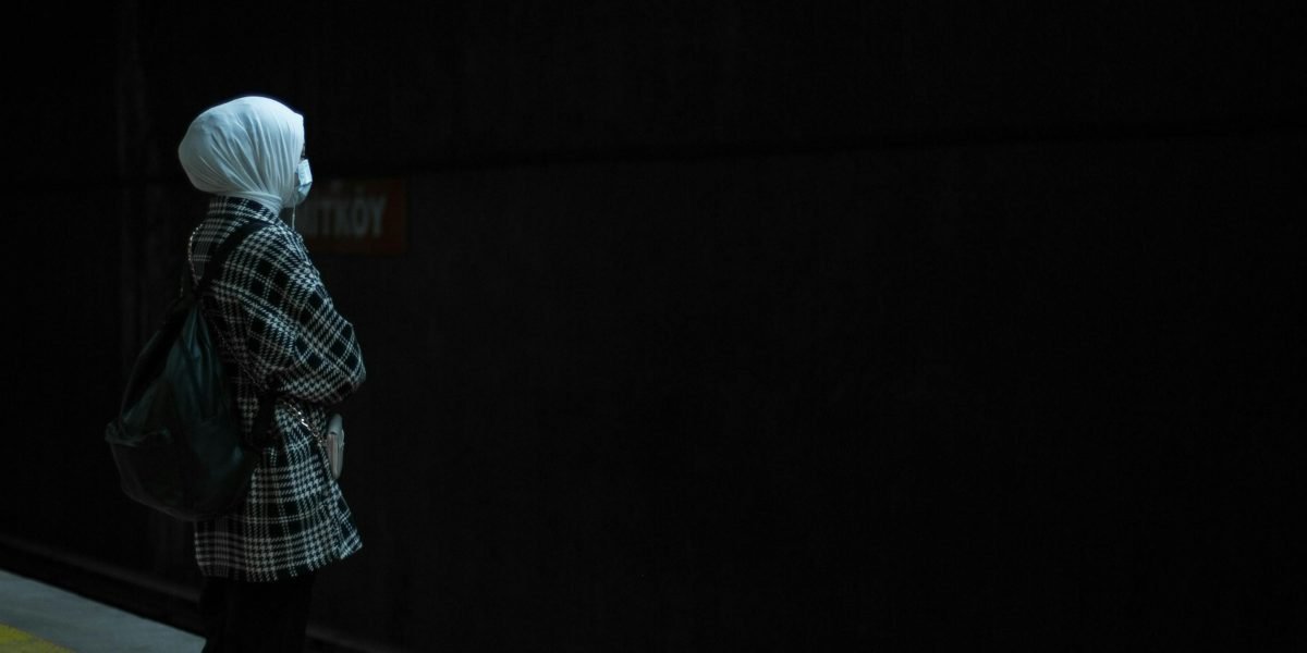A person feeling isolated and disconnected despite being surrounded by others, symbolizing subjective loneliness.