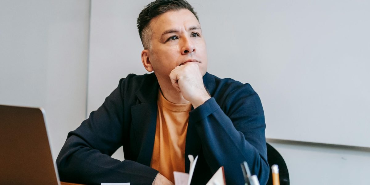 A man in deep thought, reflecting on personal challenges and potential fears of judgment.