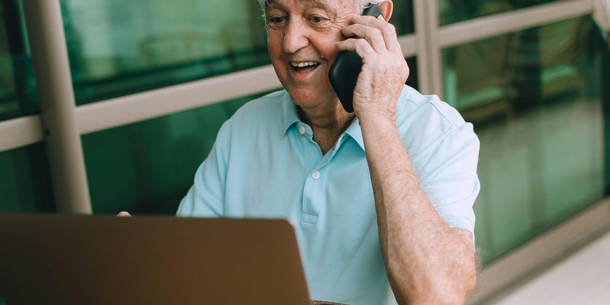 A man comfortably engaging in an online therapy or peer support group session from his home.