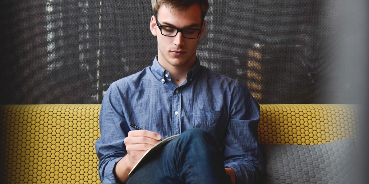A man intensely focused on work, illustrating the common coping mechanism of avoidance after a breakup.