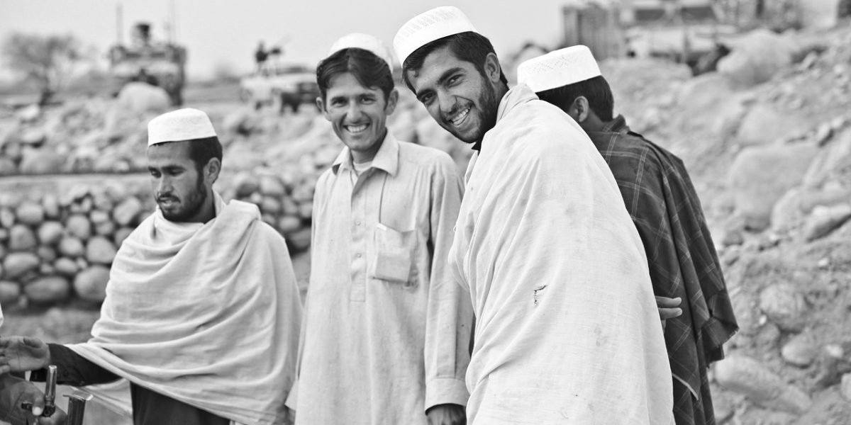 Men participating in a supportive community setting, fostering connection.
