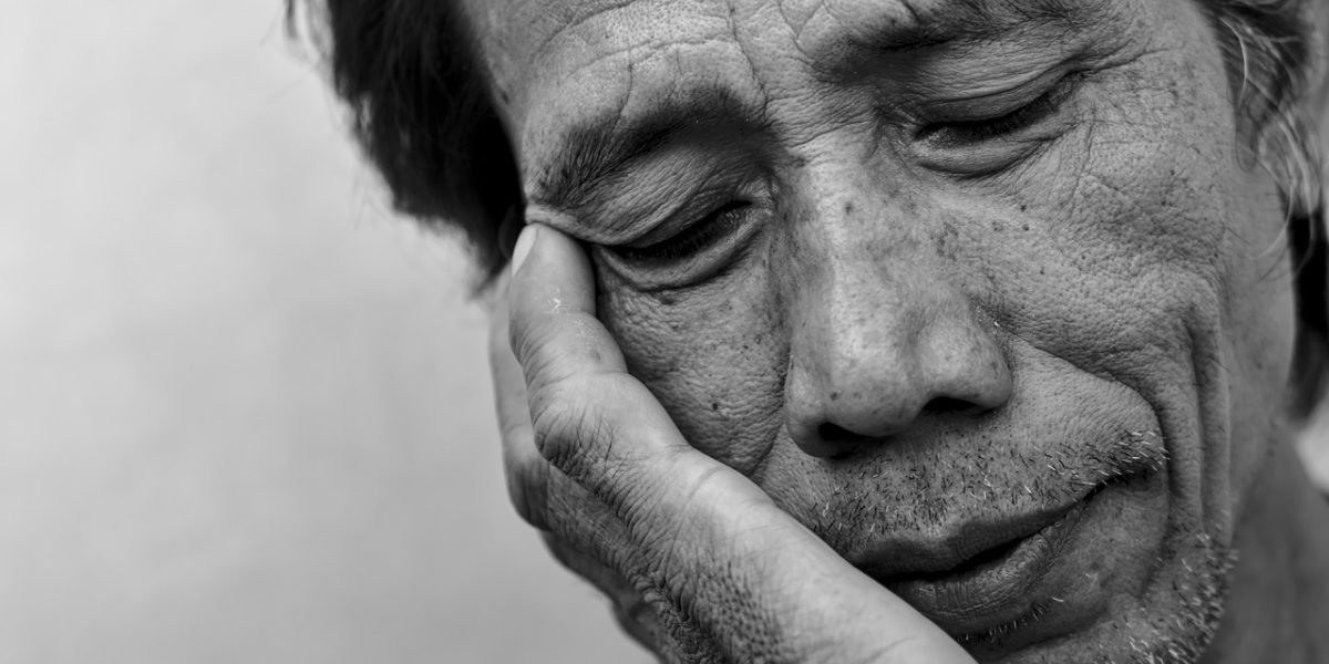 A man looking overwhelmed or fatigued, reflecting the physical and mental toll of depression.