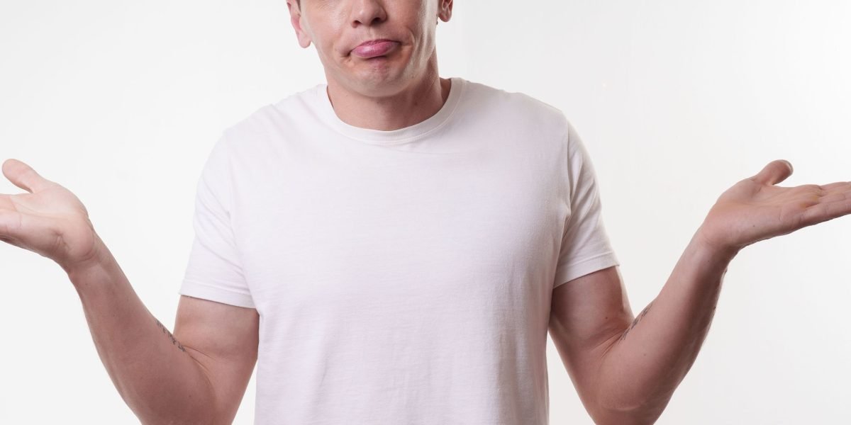 A man looking thoughtful and slightly overwhelmed, reflecting the internal confusion often experienced with complex mental health conditions.