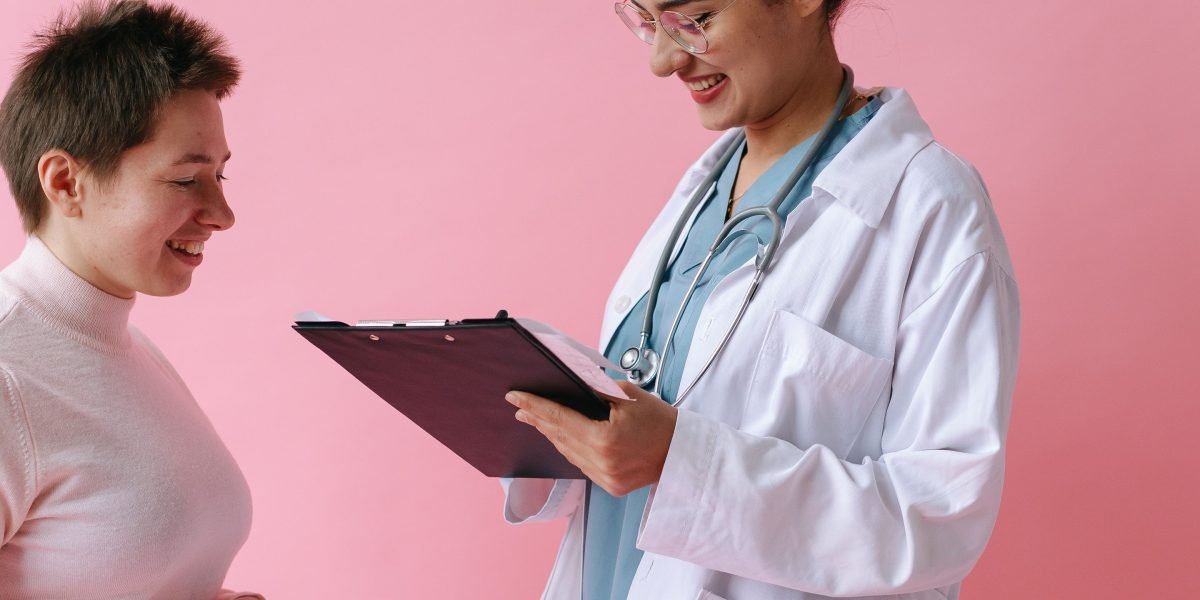 A man in a conversation with a healthcare professional, possibly accompanied by a supportive friend or family member, emphasizing open communication.