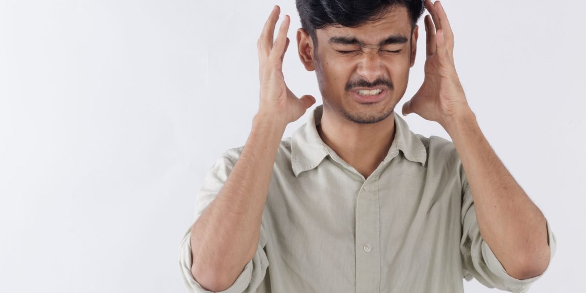 A man grappling with intense internal stress, a common manifestation of unaddressed trauma.