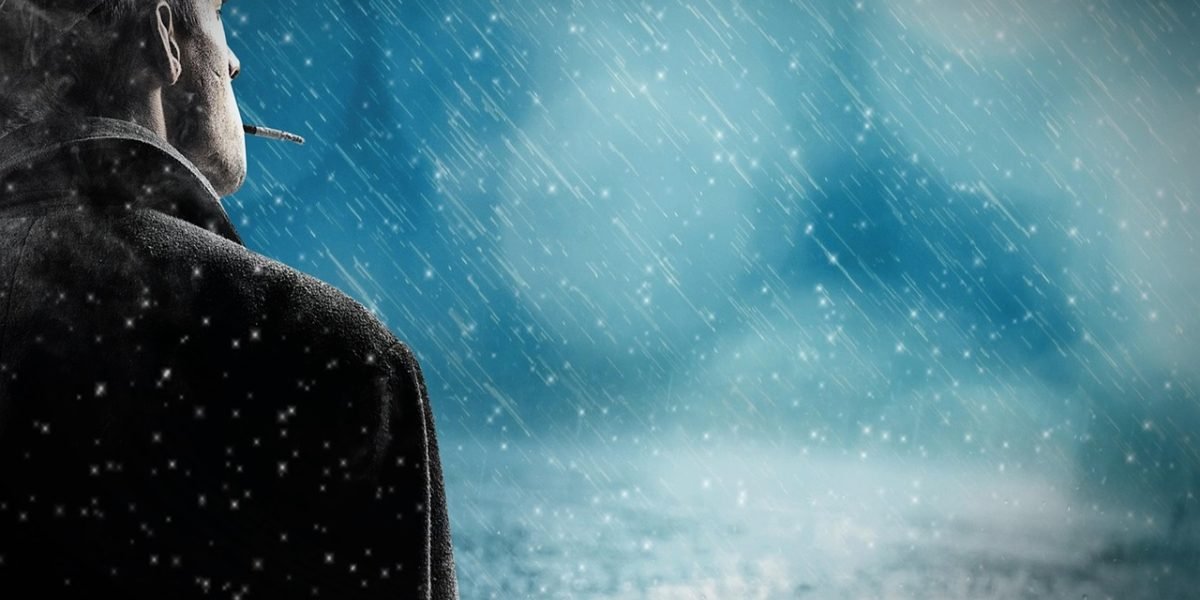 A man reflecting alone, representing the rising trend of male loneliness.