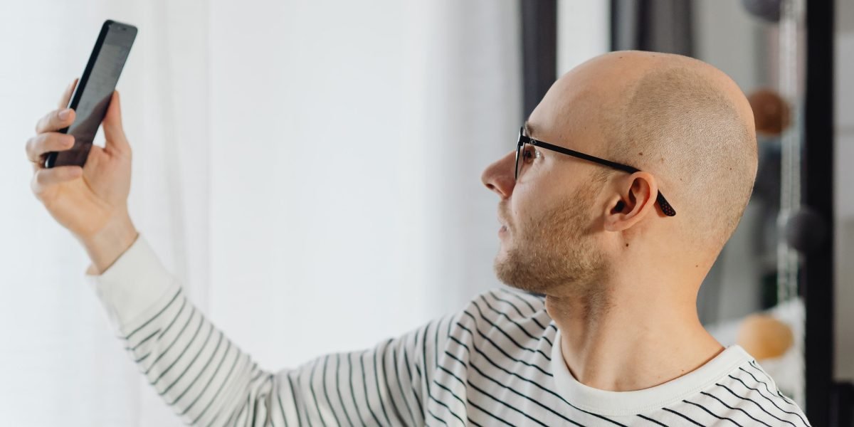 A man discreetly engaging with his phone in a private setting, illustrating comfort with digital mental health tools.