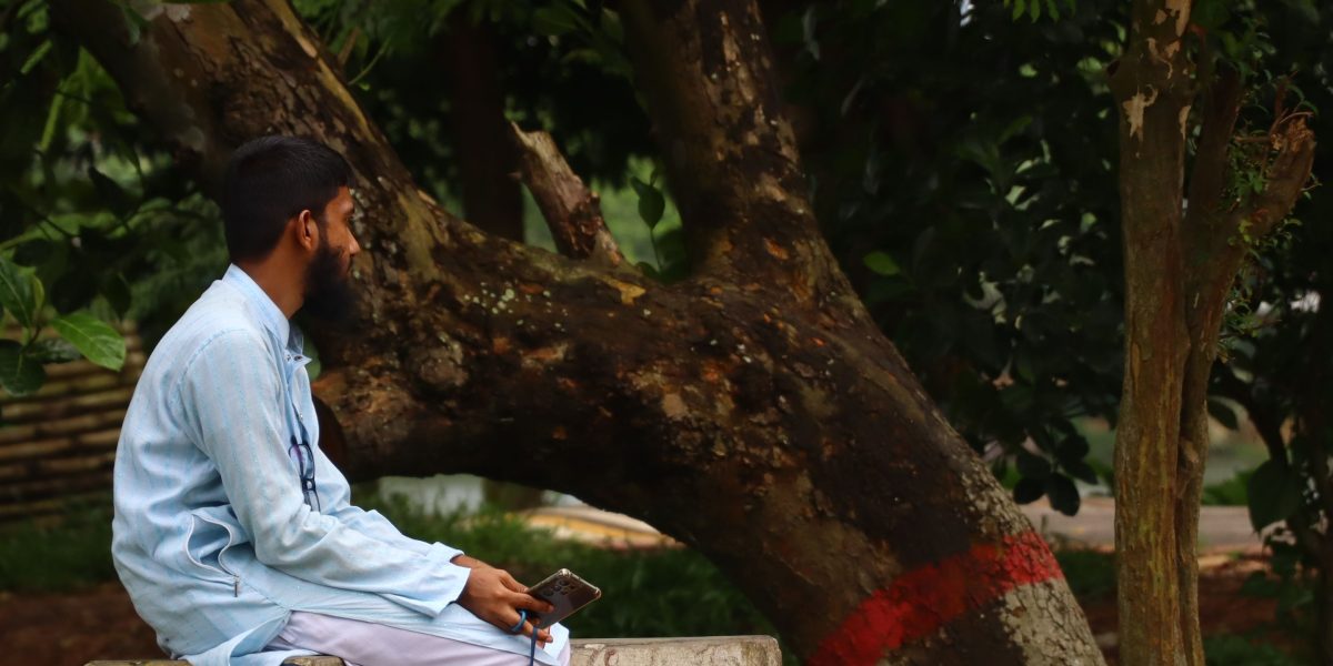 A man looking thoughtful and alone, reflecting the feeling of isolation.