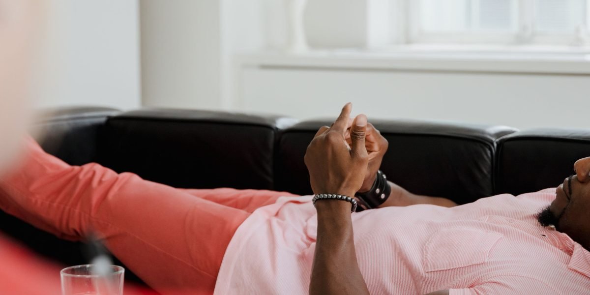 A man openly discusses his feelings with a mental health counselor, illustrating the importance of seeking professional support.