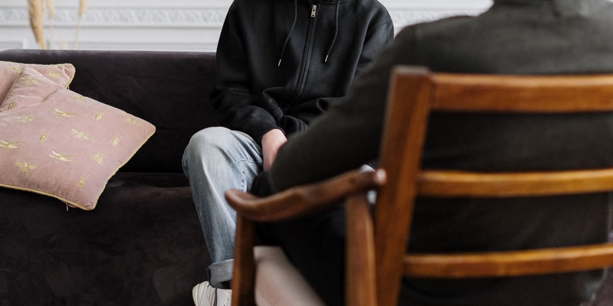 An adult and teenager engaged in a conversation, representing the diverse manifestations of manic disorder across different age groups.