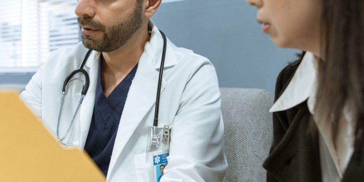 A patient and doctor engage in a discussion, symbolizing the collaborative approach to developing an effective treatment plan for manic disorder.