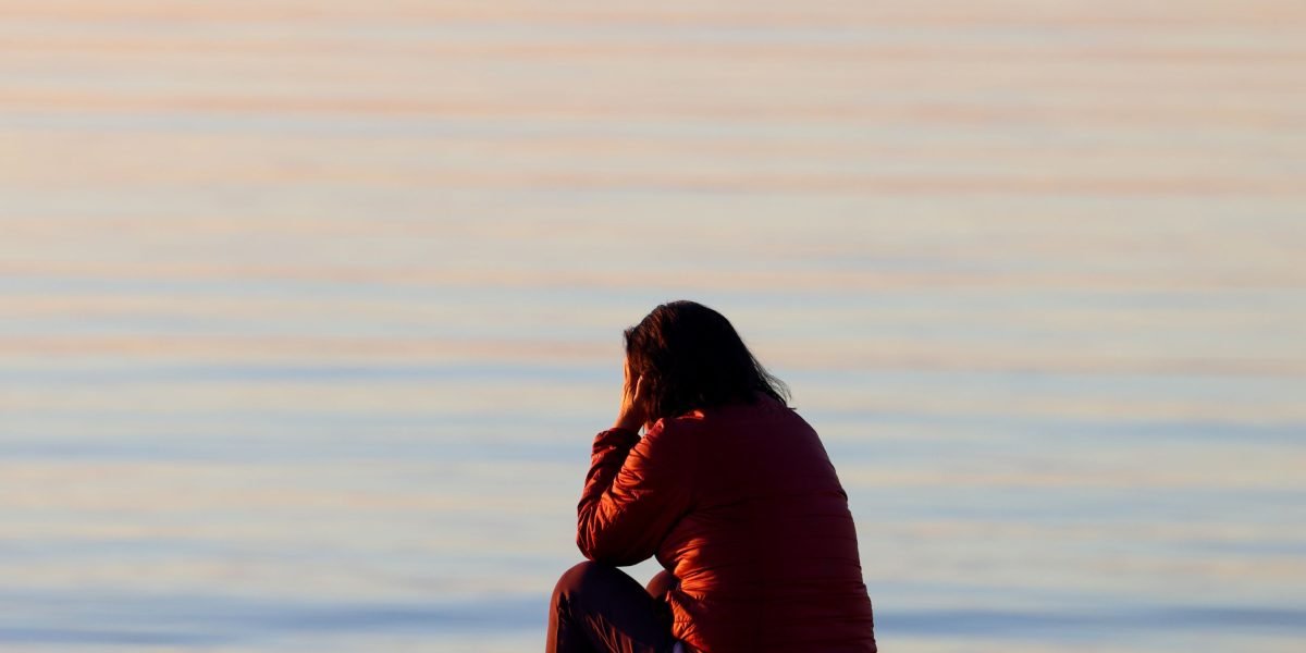 A person quietly reflecting, embodying the need for private and accessible care in their recovery journey.