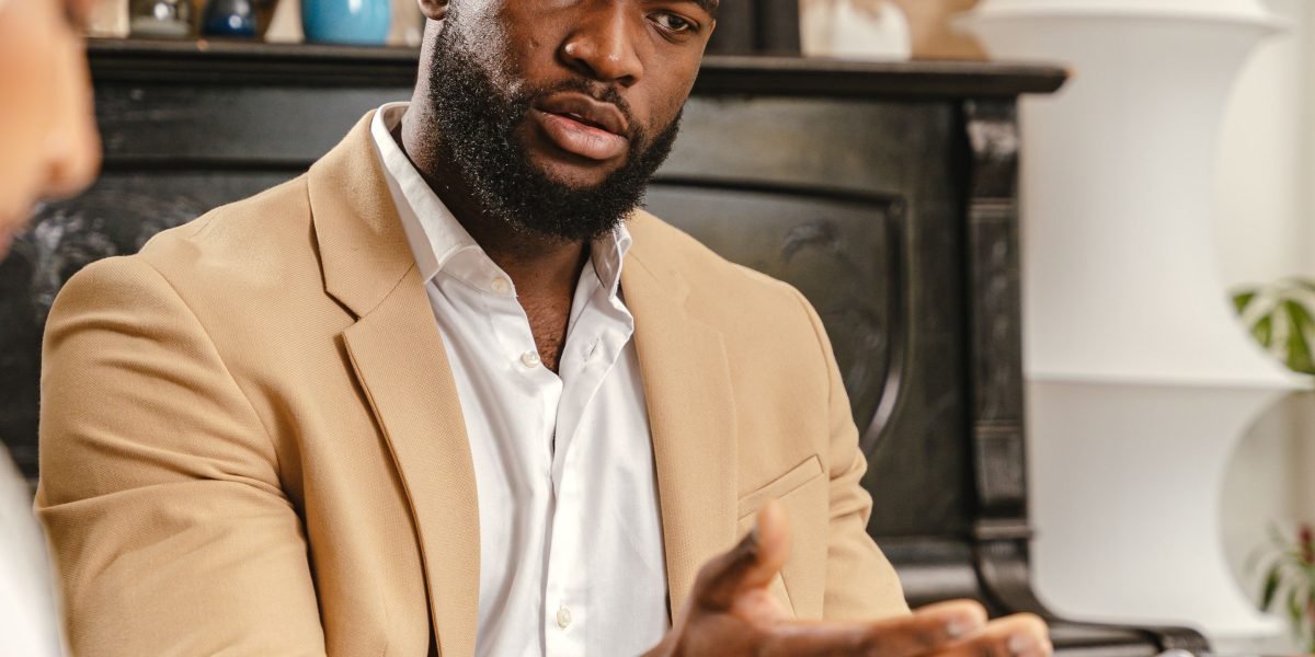 A client and therapist engage in a focused discussion, emphasizing understanding unique struggles.