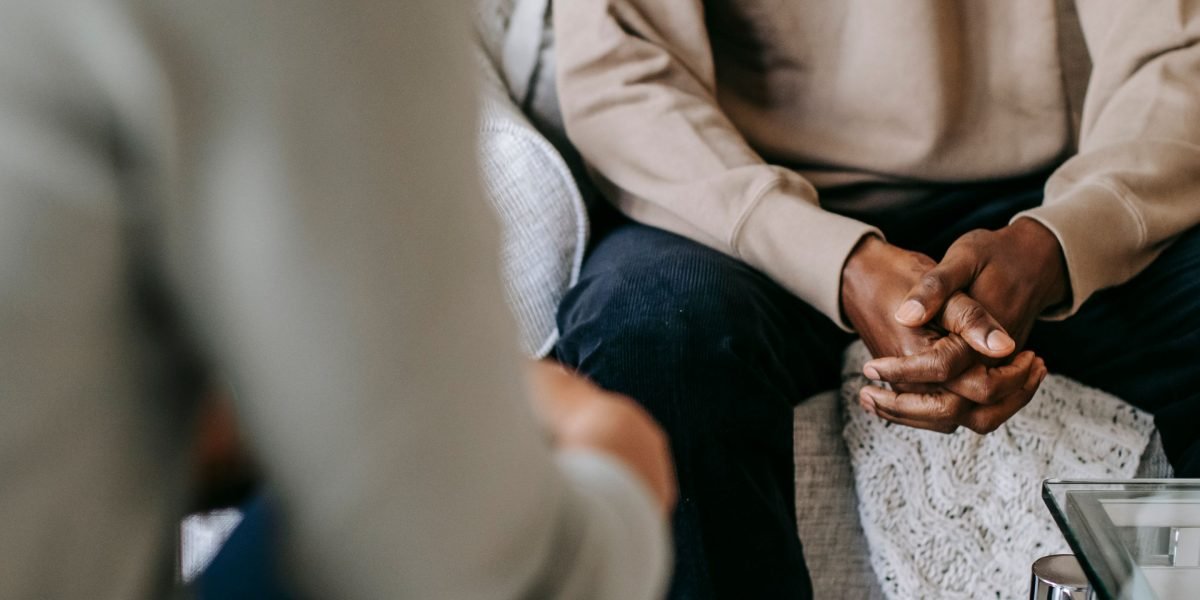 A man in a supportive conversation, feeling understood and heard, addressing complex challenges.