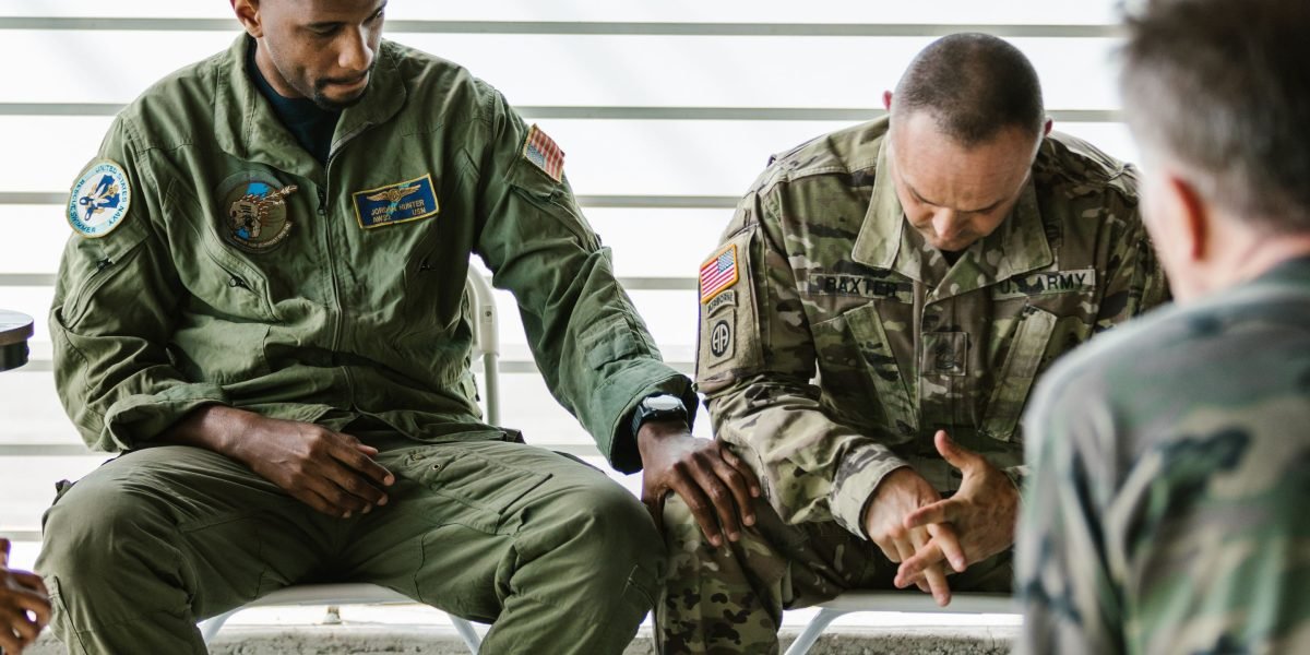 A group of men participating in an open and supportive discussion, fostering connection.