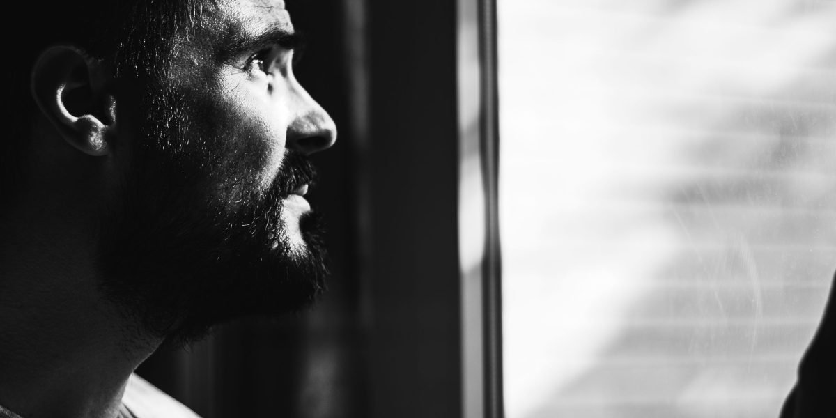 A person reflecting, symbolizing the quiet struggle of loneliness even when surrounded by others.